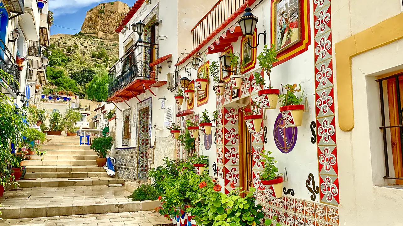 Old decorated houses in narrow street Alicante