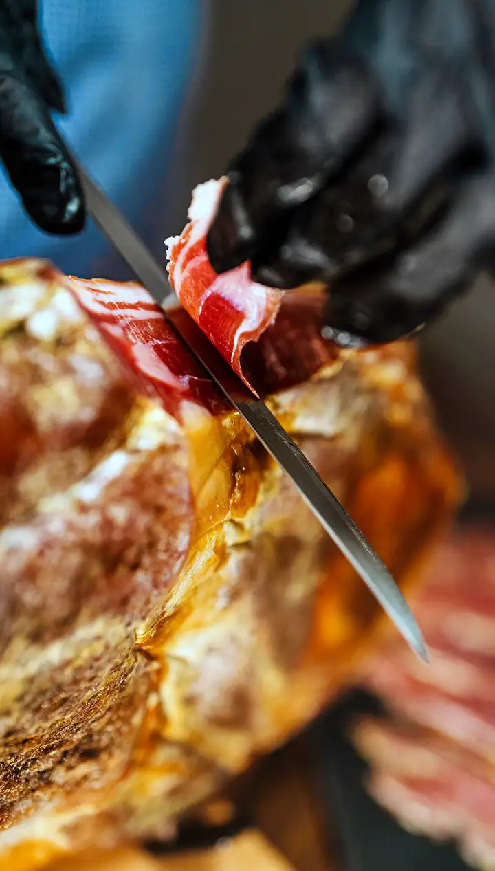 Cured Spanish Ham cutting with knife